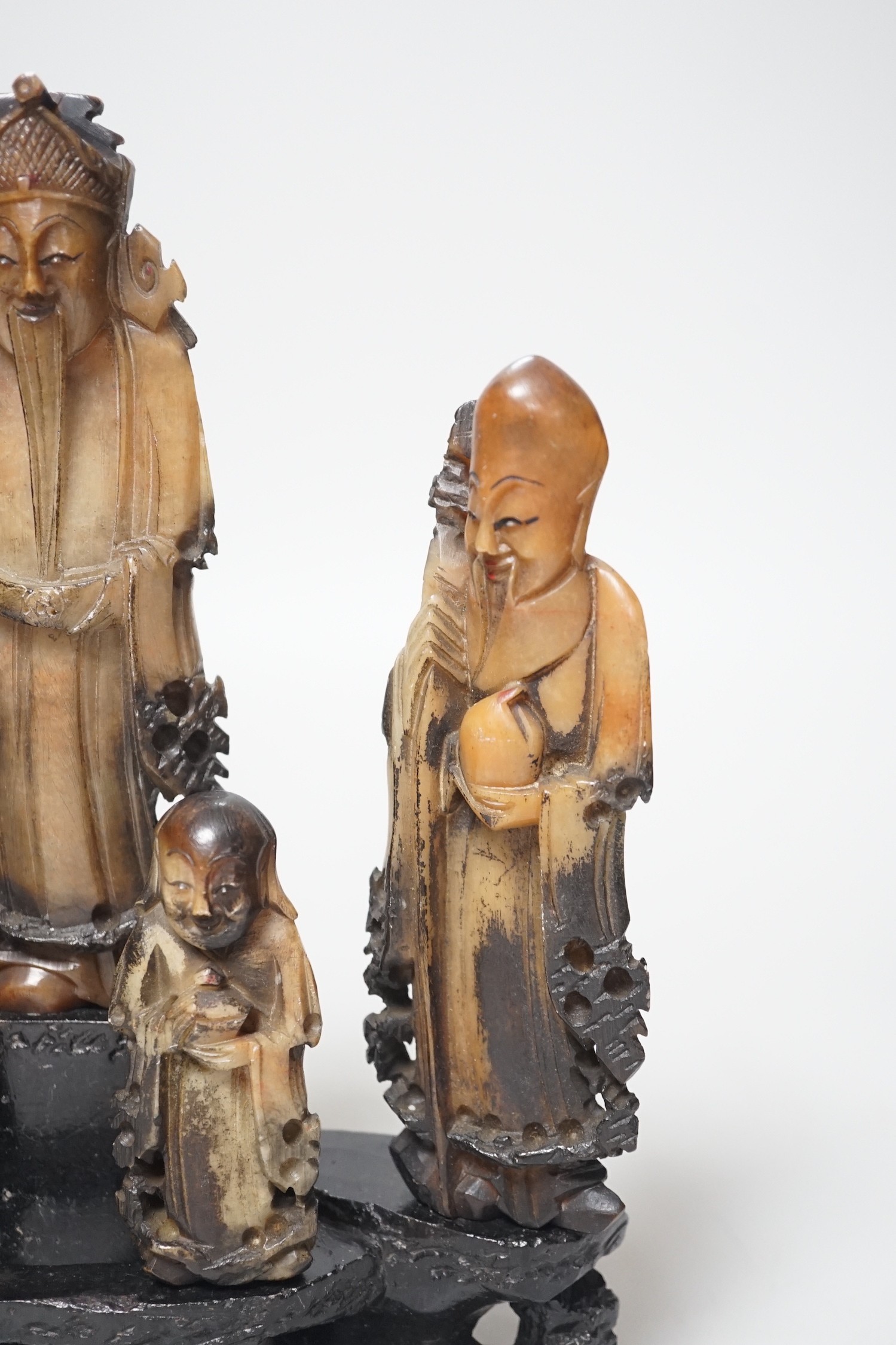 An early 20th century Chinese carved soapstone group of five deities on a rockwork base, 23cm